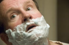 Middle-aged Caucasian man with shaving cream on his face, close-up